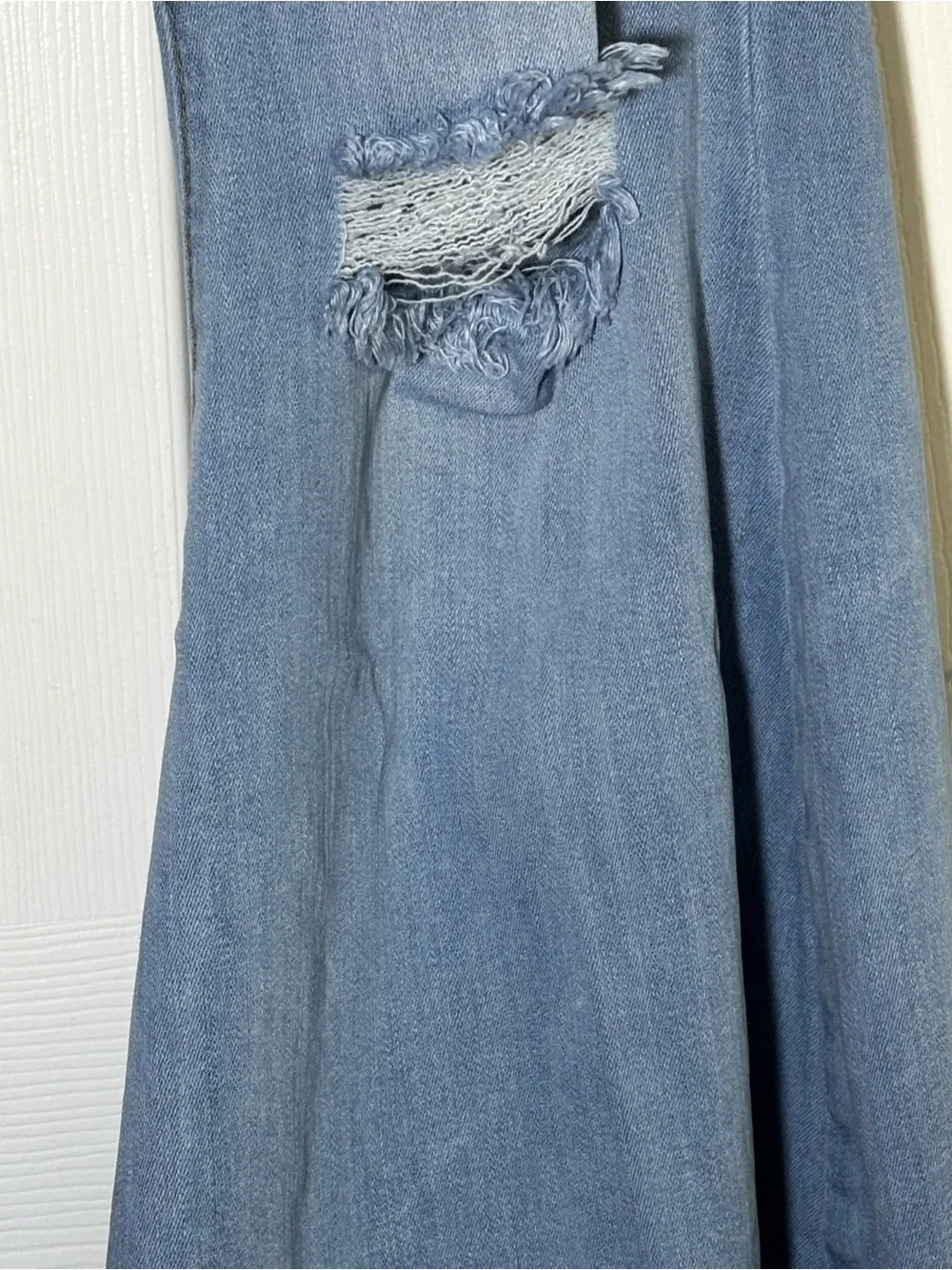 Vibrant light wash distressed flare jeans